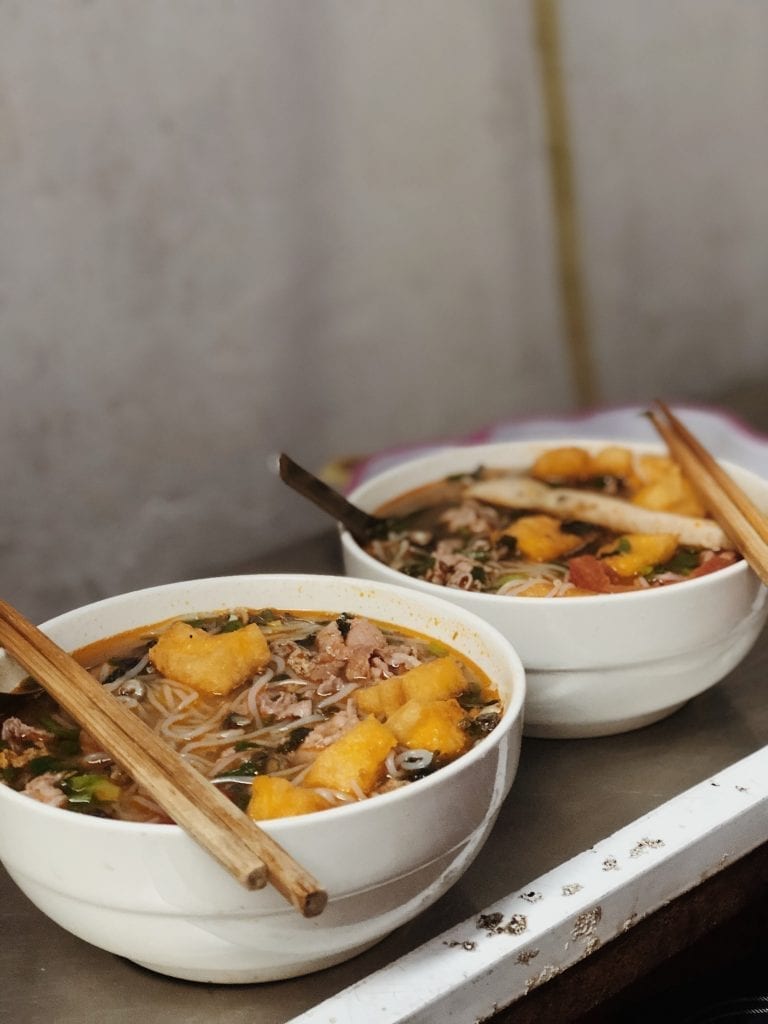 soup dish on white bowls vietnamese food