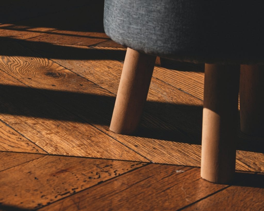 hardwood flooring black round seat on brown wooden floor