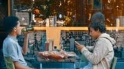 two men sitting on chair front of table