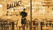 sanitation man mopping floor of Coffee Balzac's roaster