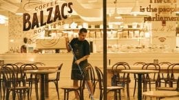 sanitation man mopping floor of Coffee Balzac's roaster